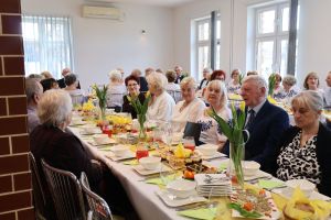 Emeryci i renciści siedzą przy stołach